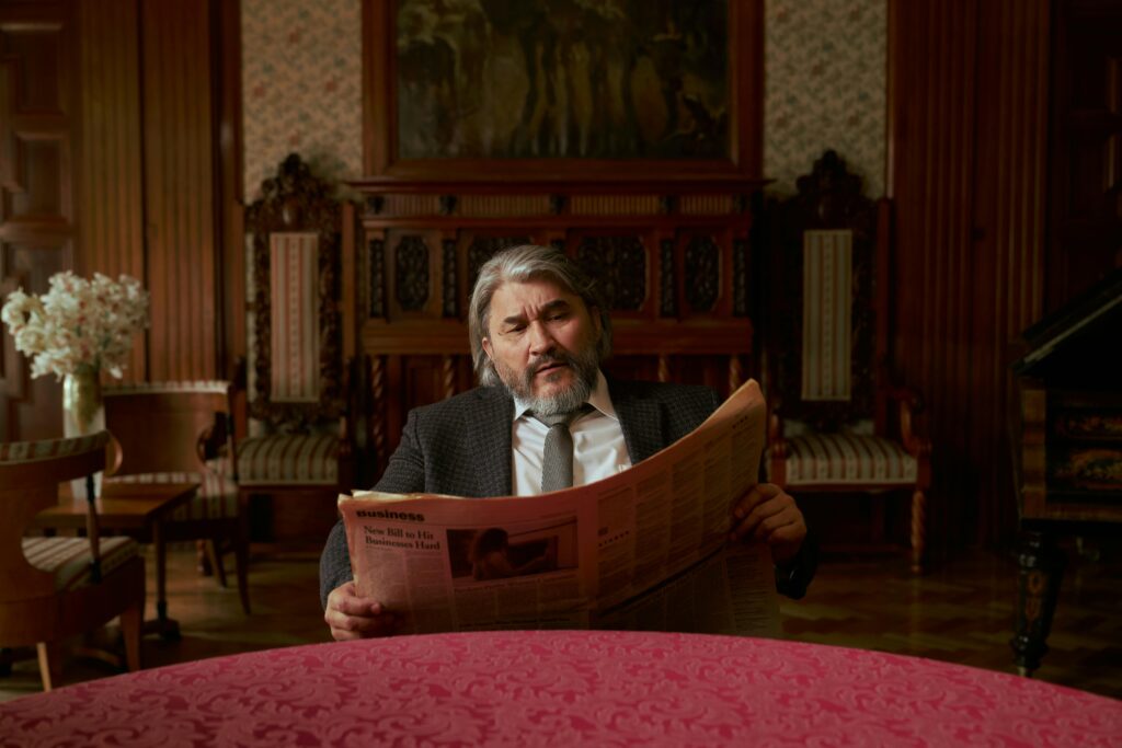 Old man reading newspaper