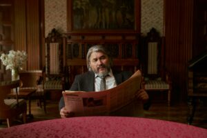 Old man reading newspaper