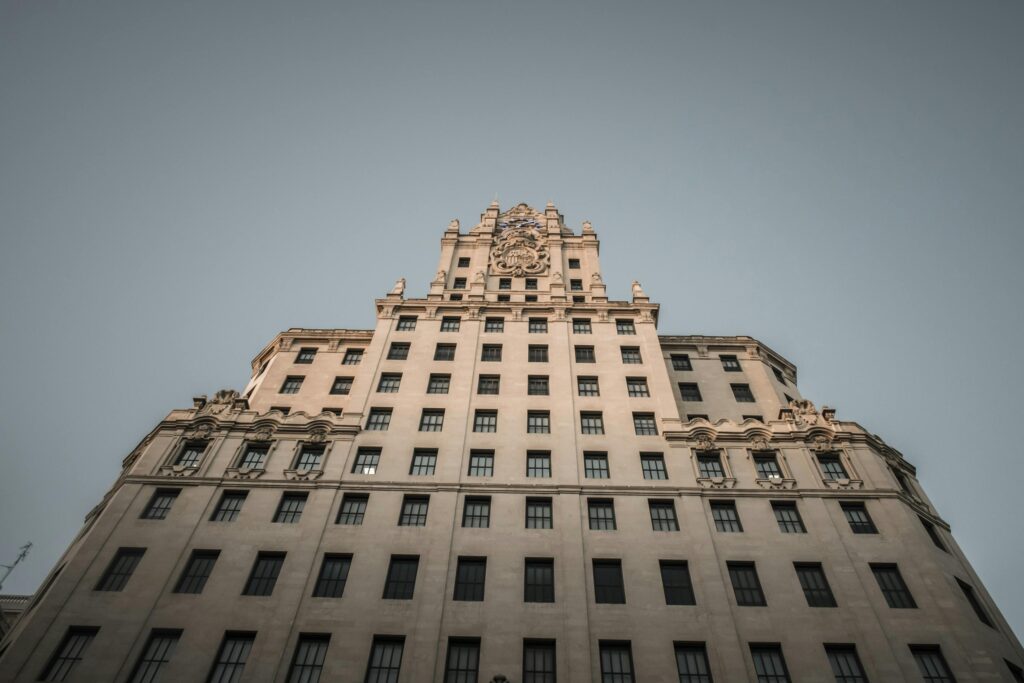 Stunning low-angle view of the iconic Telefonica Building facade in Madrid, Spain.